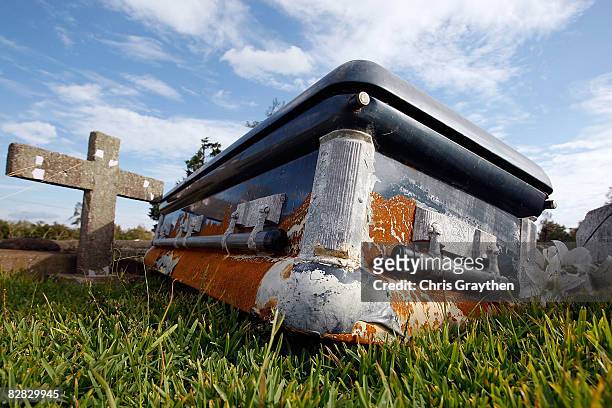 Casket rests on the open ground after floating out of its vault as a result of the storm surge associated with Hurricane Ike September 15, 2008 in...