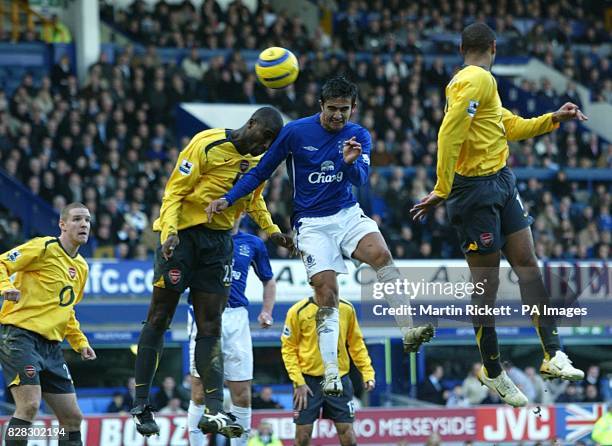 Everton's Tim Cahill challenges Arsenal's Sol Campbell for a header