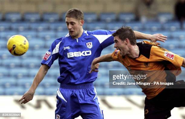 Millwall's Ben May challenges Wolverhampton Wanderers' Rob Edwards during the Coca-Cola Championship match at The Den, London, Saturday January 21,...