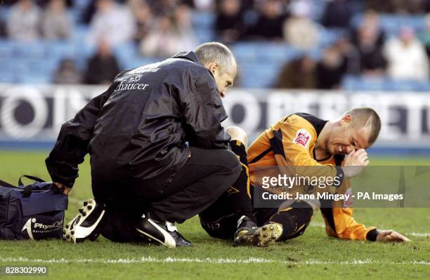 Wolverhampton Wanderers' Kenny Miller receives attention after being injured against Millwall during the Coca-Cola Championship match at The Den,...
