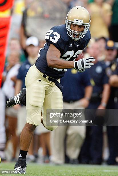 Golden Tate of the Notre Dame Fighting Irish carries the ball during the game against the Michigan Wolverines on September 13, 2008 at Notre Dame...