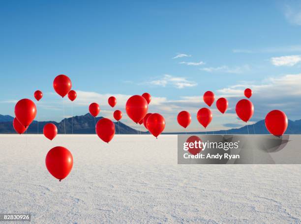 group of red balloons on salt flats. - out of context ストックフォトと画像