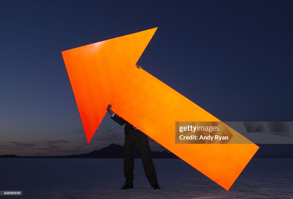Man Holding Giant Reflective Arrow, Salt Flats 