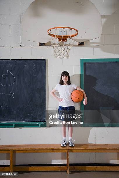 girl standing on bench with basketball - blackboard qc stock pictures, royalty-free photos & images