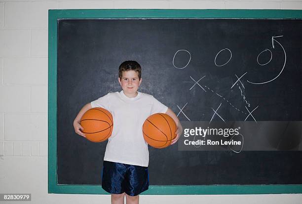 young boy holding two basketballs - blackboard qc stock pictures, royalty-free photos & images