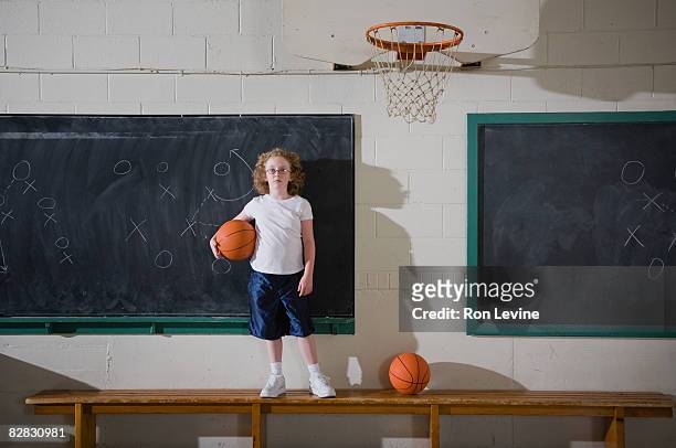 young girl holding basketball in gym, portrait - blackboard qc stock pictures, royalty-free photos & images