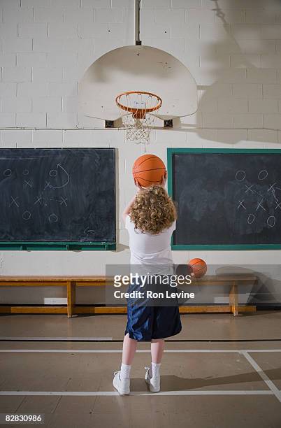 young girl lining up a basketball shot - blackboard qc stock pictures, royalty-free photos & images