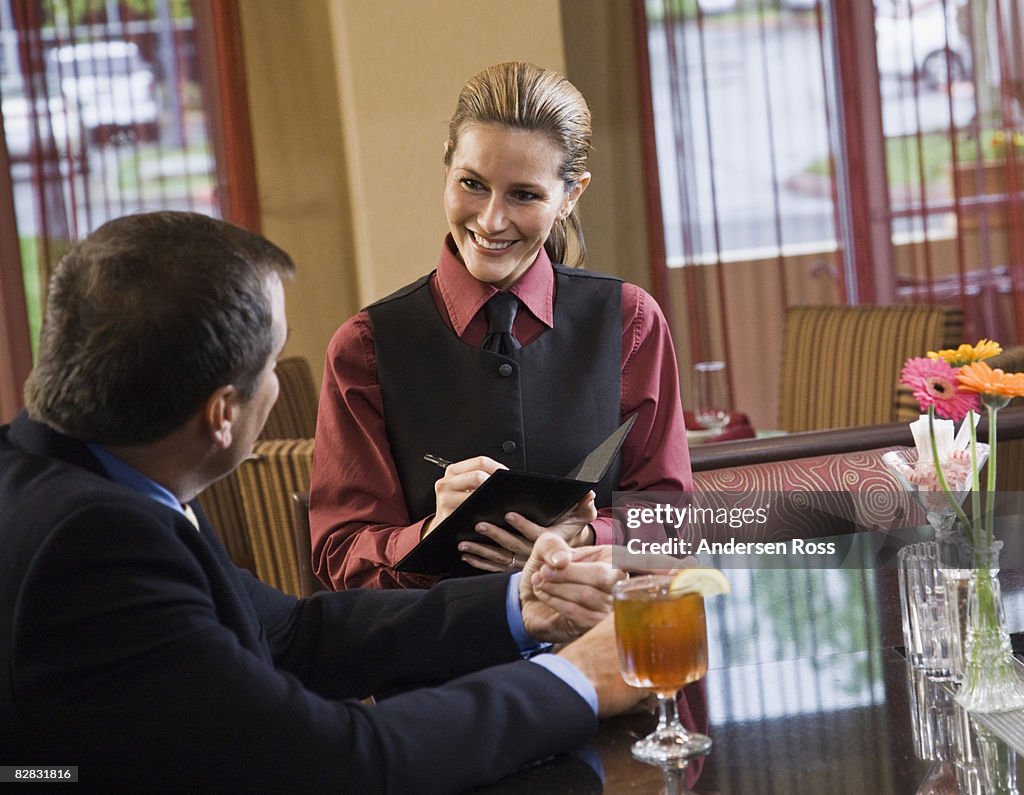 Waitress taking a male patron's order