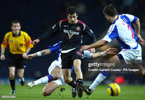 Blackburn Rovers Robbie Savage challenges Sunderland's Julio Arca as referee Keith Stroud looks on