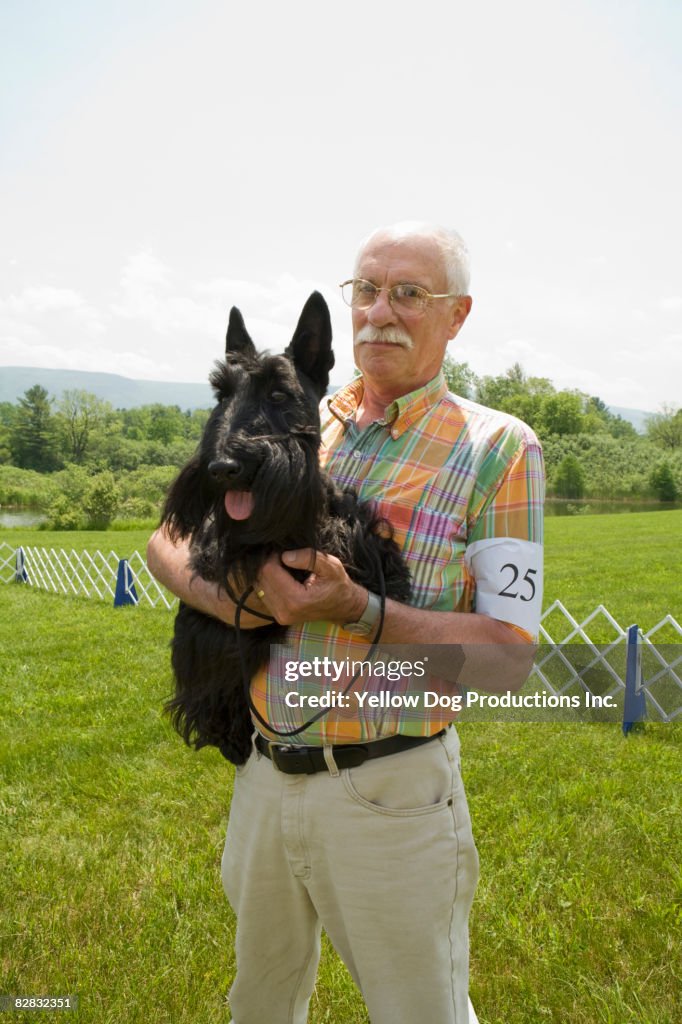 Portrait of senior man and his dog at dog show