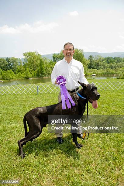 portrait of owner with his winning great dane - dog show stock pictures, royalty-free photos & images