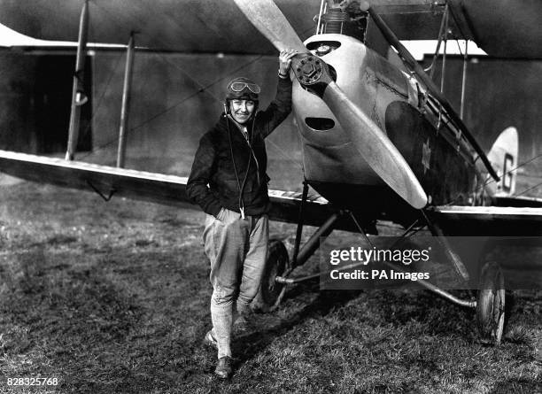 British Aviatrix Amy Johnson, with her 'Jason' Gypsy Moth at the London Aeroplane Club, is the first woman to gain Air Ministry's ground engineer's...