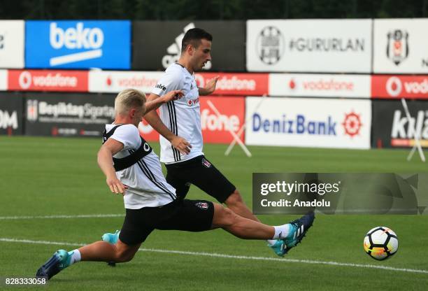 Andreas Beck and Oguzhan Ozyakup of Besiktas attend a training session ahead of the Turkish Spor Toto Super Lig new season match between Besiktas and...