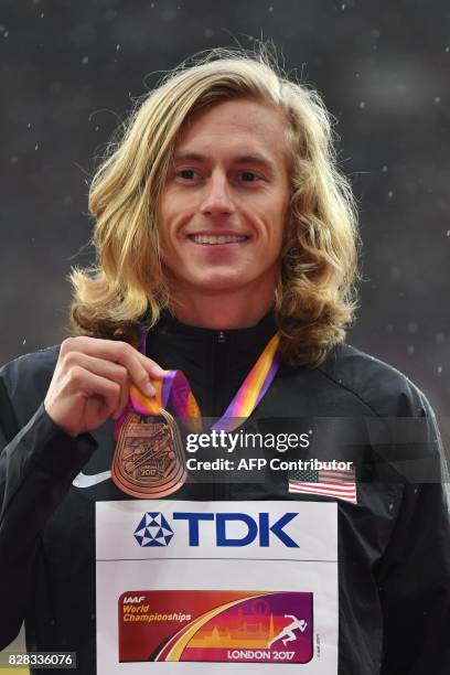 Bronze medallist US athlete Evan Jager poses on the podium during the victory ceremony for the men's 3,000m steeplechase athletics event at the 2017...