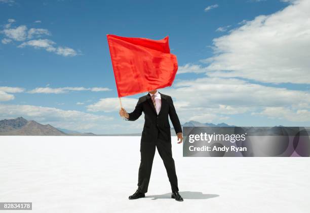 business waving red flag on salt flats. - holding flag stock pictures, royalty-free photos & images