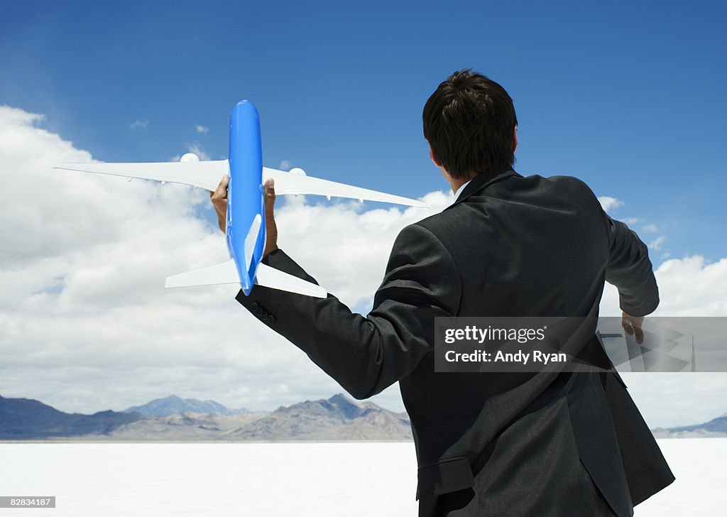 Businessman Throwing Small Airplane
