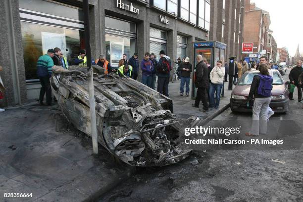 Burned out car sits in Dublin's Nassau Street after serious rioting between police and Nationalist protesters, Saturday February 25, 2006. Hundreds...