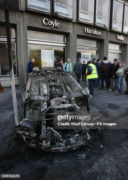 Burned out car sits in Dublin's Nassau Street after serious rioting between police and Nationalist protesters, Saturday February 25, 2006. Hundreds...