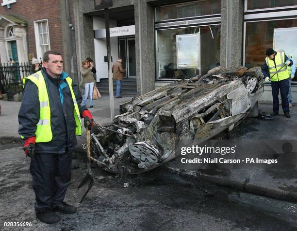 Burned out car sits in Dublin's Nassau Street after serious rioting between police and Nationalist protesters, Saturday February 25, 2006. Hundreds...