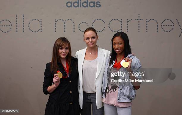 Stella McCartney poses with Olympic medalists Victoria Pendleton and Allyson Felix at the adidas by Stella McCartney Spring Summer 2009 show during...