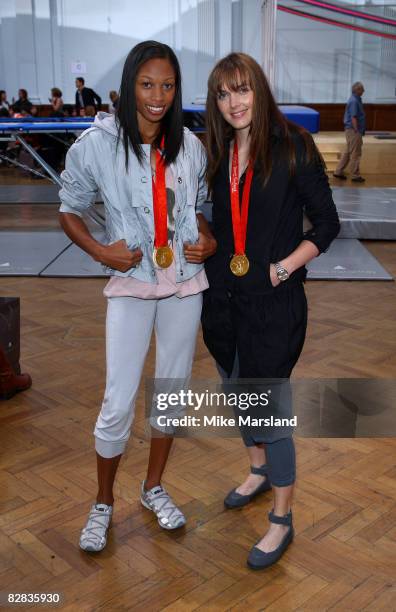Stella McCartney poses with Olmpic medalists Victoria Pendleton and Allyson Felix at the adidas by Stella McCartney Spring Summer 2009 show during...