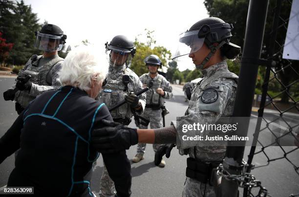 Protester is arrested by Lawrence Livermore Laboratory police during a demonstration against nuclear weapons outside of the Lawrence Livermore...