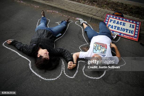Protesters stage a die-in during a demonstration against nuclear weapons outside of the Lawrence Livermore National Laboratory on August 9, 2017 in...