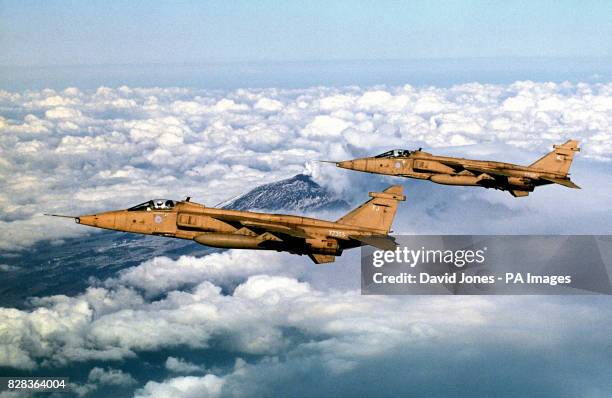 Jaguars from 41 Squadron, based at RAF Coltishall flown by Sqn Ldr Chris Allam and Hauptman Dieter Knorr fly over the smoking crater of Mount Etna on...