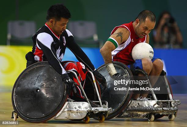 Troye Collins of Great Britain evades Say Luangkhamdeng of Canada during the Wheelchair Rugby match between Great Britain and Canada at the Beijing...