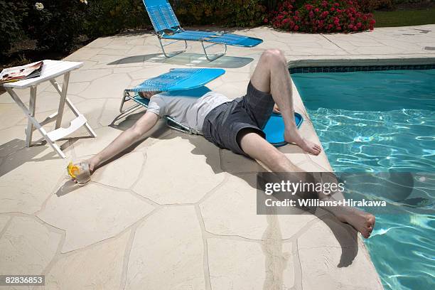 man caught in collapsed deck chair - broken deckchair stock pictures, royalty-free photos & images