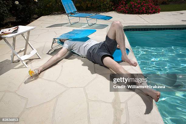 man caught in collapsed deck chair - broken spectacles stock pictures, royalty-free photos & images