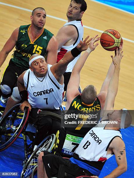 Australia's Shaun Norris vies for the rebound with Canada's Richard Peter and Chris Stoutenberg as Joey Johnson and Brad Ness look on in their men's...