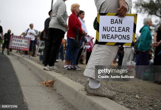 Protesters holds signs during a demonstration against nuclear weapons outside of the Lawrence Livermore National Laboratory on August 9, 2017 in...