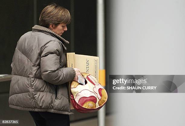 Woman carries a box as she leaves the Lehman Brothers European Headquarters building in Canary Wharf in east London on September 16, 2008. World...