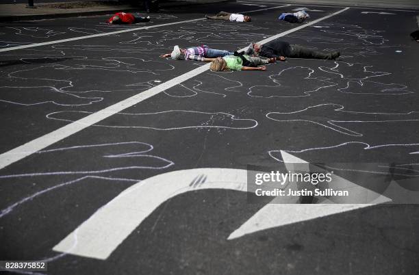 Protesters stage a die-in during a demonstration against nuclear weapons outside of the Lawrence Livermore National Laboratory on August 9, 2017 in...