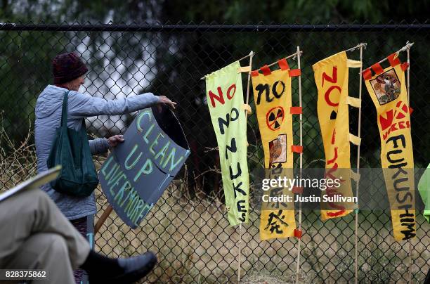 Protester holds a sign during a demonstration against nuclear weapons outside of the Lawrence Livermore National Laboratory on August 9, 2017 in...