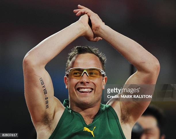 Oscar Pistorius of South Africa celebrates after winning the final of the men's 400 metre T44 classification event at the 2008 Beijing Paralympic...