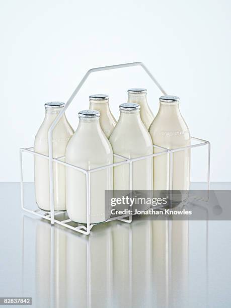 milk holder with milk bottles - milk bottle foto e immagini stock