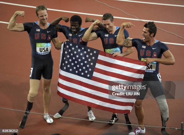 Casey Tibbs, Jerome Singleton, Brian Frasure, Jim Bob Bizzell of the US celebrate with the US flag after winning the men's 4x100m relay T42-T46 final...