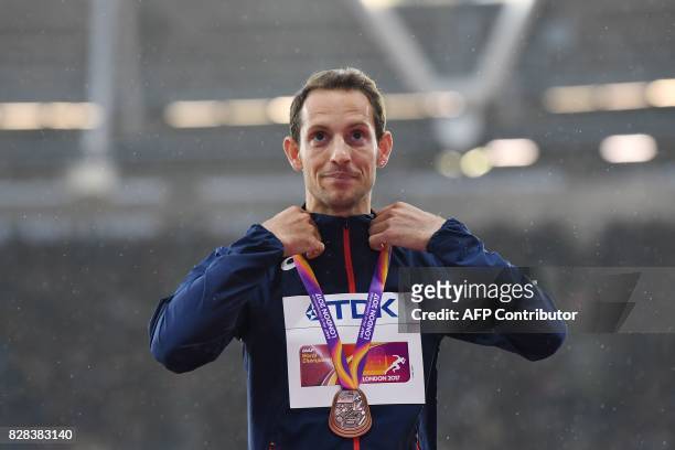 Bronze medallist France's Renaud Lavillenie poses on the podium during the victory ceremony for the men's pole vault athletics event at the 2017 IAAF...
