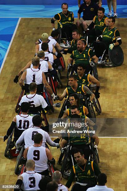 Players of the United States and Australia shake hands after the final match of the Mixed Wheelchair Rugby at Beijing Science and Technology...