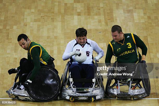 Norm Lyduch of the United States is tackled by Cameron Carr and Ryley Batt of Australia during the final match of the Mixed Wheelchair Rugby at...