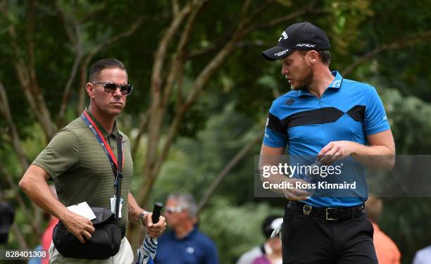 Swing coach Sean Foley talks with Danny Willett of England during a practice round prior to the 2017 PGA Championship at Quail Hollow Club on August...