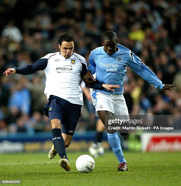 West Ham United's Matthew Etherington battles with Manchester City's Micah Richards for the ball during the FA Cup sixth round match at the City of...