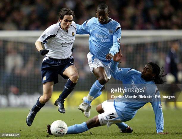West Ham United's Yossi Benayoun is challenged by Manchester City's Kiki Musampa and Bradley Wright-Phillips during the FA Cup sixth round match at...