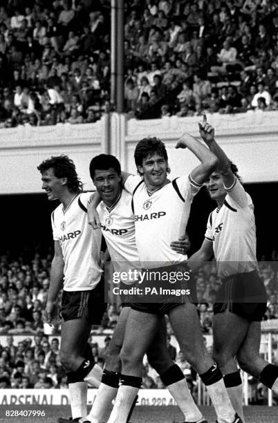 Paul McGrath celebrates scoring United's second goal with team mates Bryan Robson, Norman Whiteside and Mark Hughes.