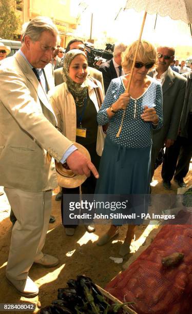 The Prince of Wales and the Duchess of Cornwall inspect one of the vegtable stalls in the western Egyptian desert town of Siwa, Thursday March 23,...