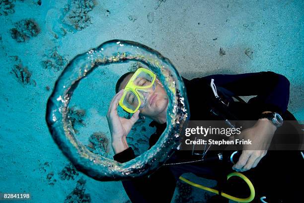 scuba diver blows air bubble rings - elevated view circle stock pictures, royalty-free photos & images