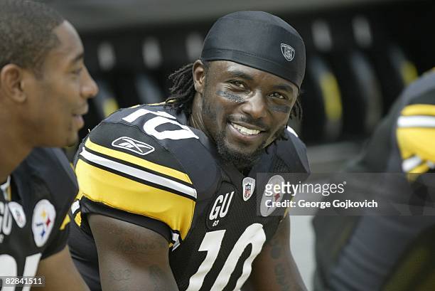 Wide receiver Santonio Holmes of the Pittsburgh Steelers smiles as he looks on from the sideline during a game against the Houston Texans at Heinz...