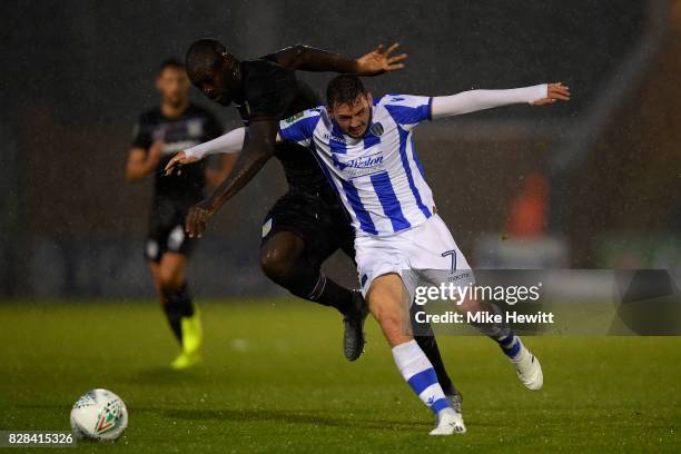 Christopher Samba of Aston Villa challenges Drey Wright of Colchester during the Carabao Cup First Round match between Colchester United and Aston...